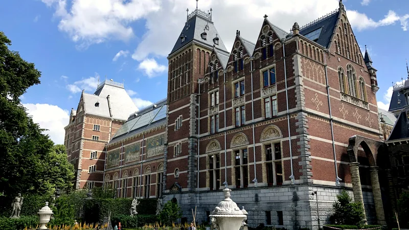 The brick towers of the Rijksmuseum under a bright sky