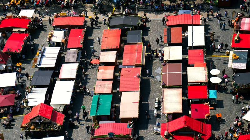 Rows of brightly roofed market stalls seen from above