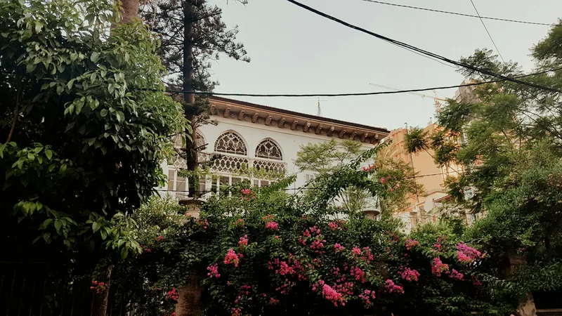 A heritage building with arched windows and bougainvillea in Beirut