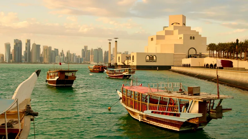 Wooden dhows moored in front of the Museum of Islamic Art and the Doha skyline