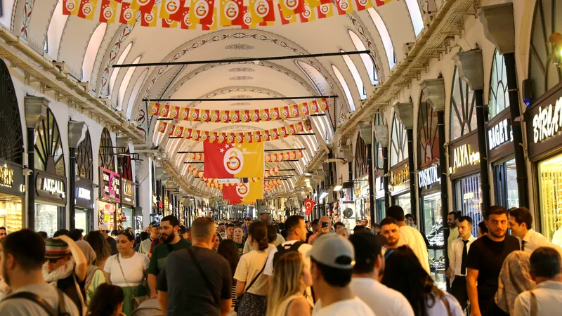 Shoppers under the painted vaulted ceiling of a covered lane in the Grand Bazaar