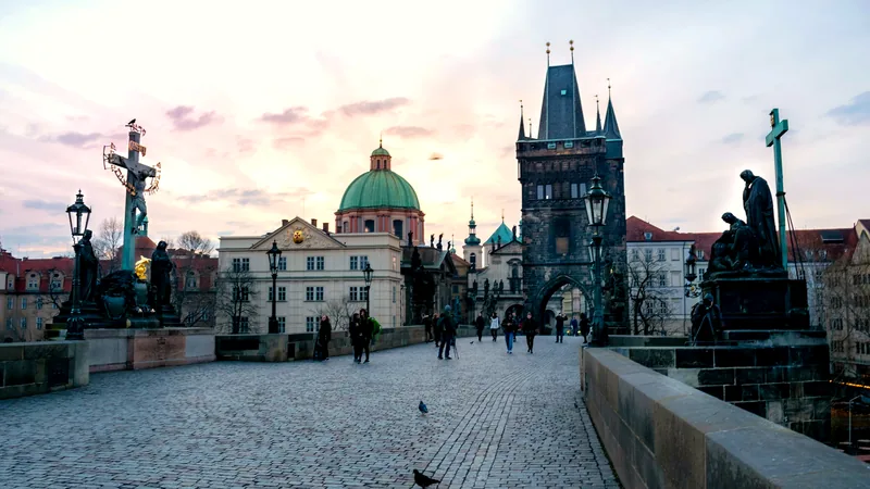 Statues and towers along Charles Bridge in early morning light