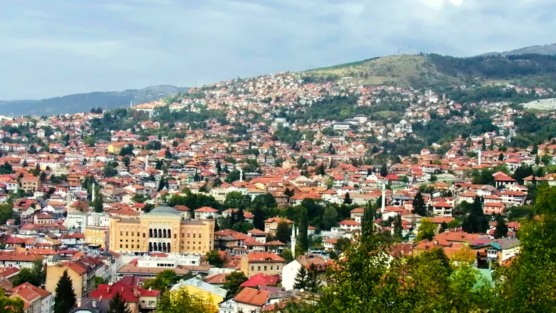 Sarajevo spread across its valley, seen from the surrounding green hills