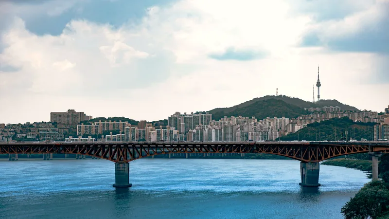 A bridge over the Han River with Seoul and Namsan hill beyond