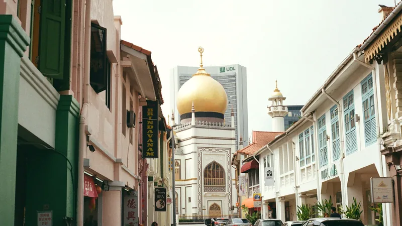 The golden dome of the Sultan Mosque at the end of a Kampong Glam street