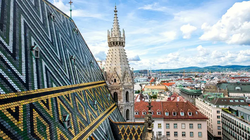 The patterned tiled roof and spire of St Stephen's Cathedral above Vienna